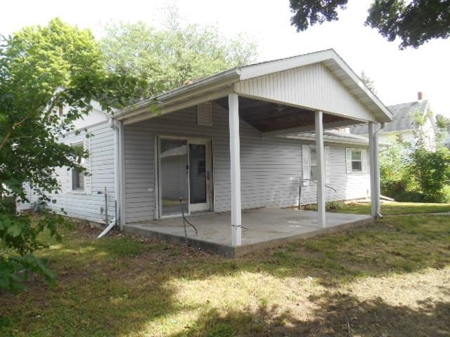 424 North 10th Street Rochelle, IL 61068 - Photo 18 of 22 a view of a house with a yard potted plants and a large tree