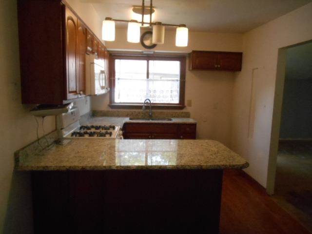 424 North 10th Street Rochelle, IL 61068 - Photo 5 of 22 a kitchen with a sink a stove and cabinets