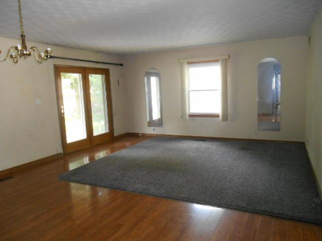 424 North 10th Street Rochelle, IL 61068 - Photo 8 of 22 an empty room with wooden floor and windows
