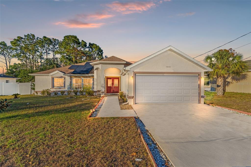 10451 Keystone Street Spring Hill, FL 34608 - Photo 1 of 1 a front view of a house with a yard