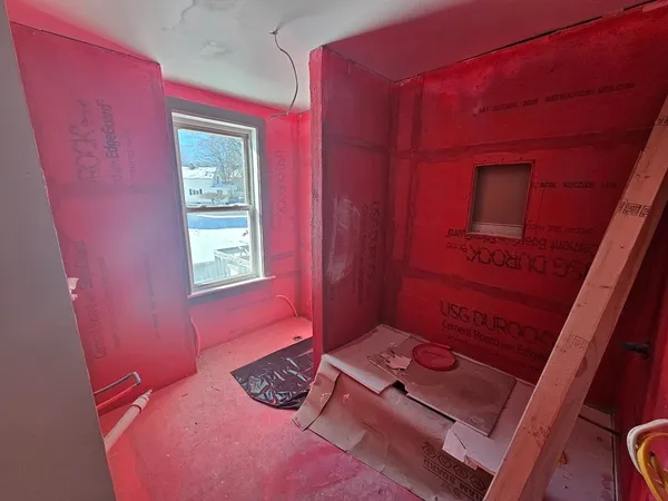 a bedroom with a bed and a mirror