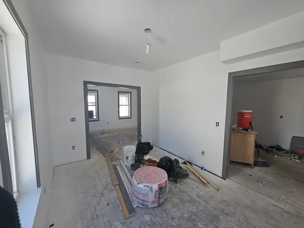 an empty room with windows and closet