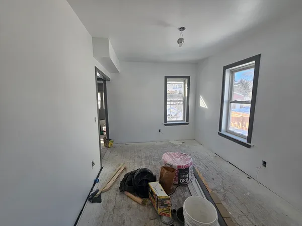 a view of an empty room with a painting
