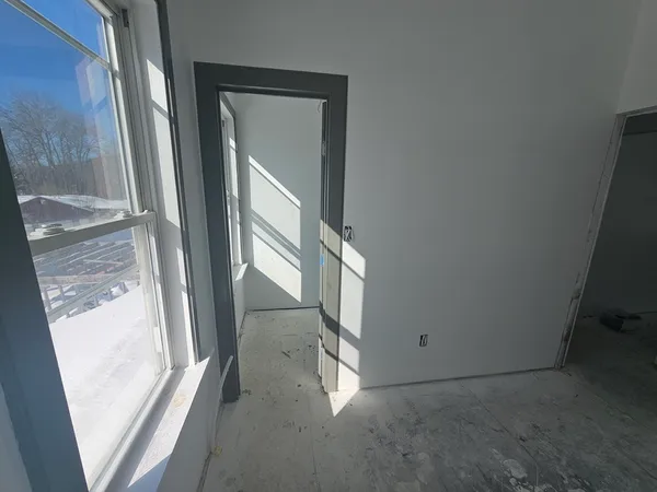 a bedroom with a bed and window