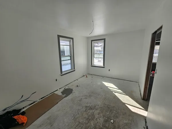a bath room with a bed and a window