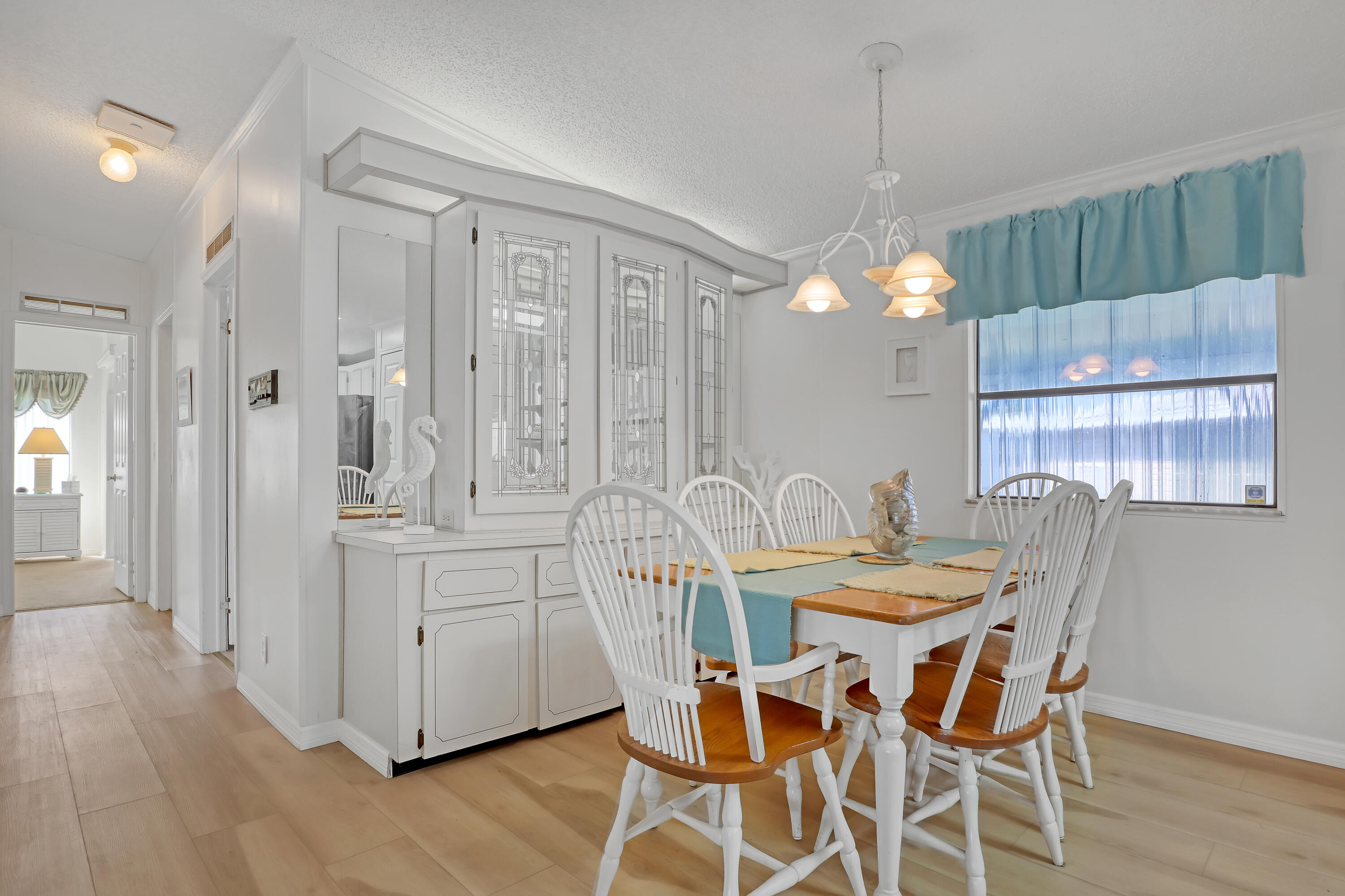 464 Dolphin Circle Barefoot Bay, FL 32976 - Photo 11 of 42 a view of a dining room with furniture and wooden floor