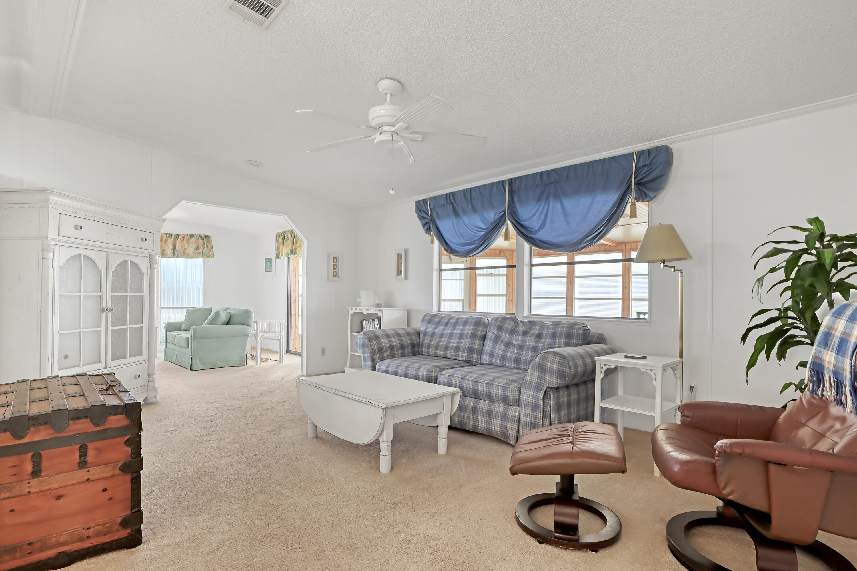 464 Dolphin Circle Barefoot Bay, FL 32976 - Photo 13 of 42 a living room with furniture and a large window