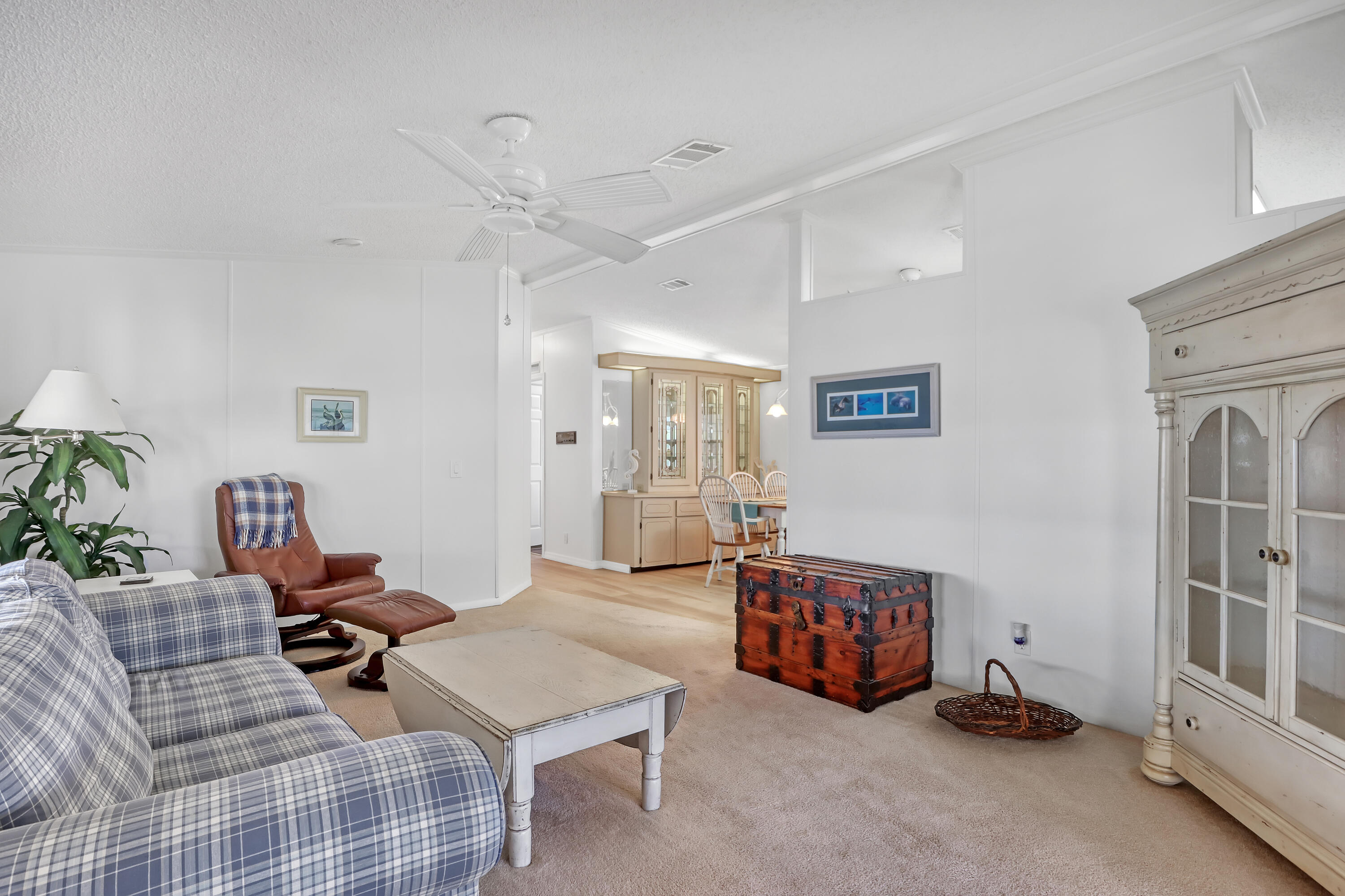464 Dolphin Circle Barefoot Bay, FL 32976 - Photo 14 of 42 a living room with furniture a rug and a chandelier