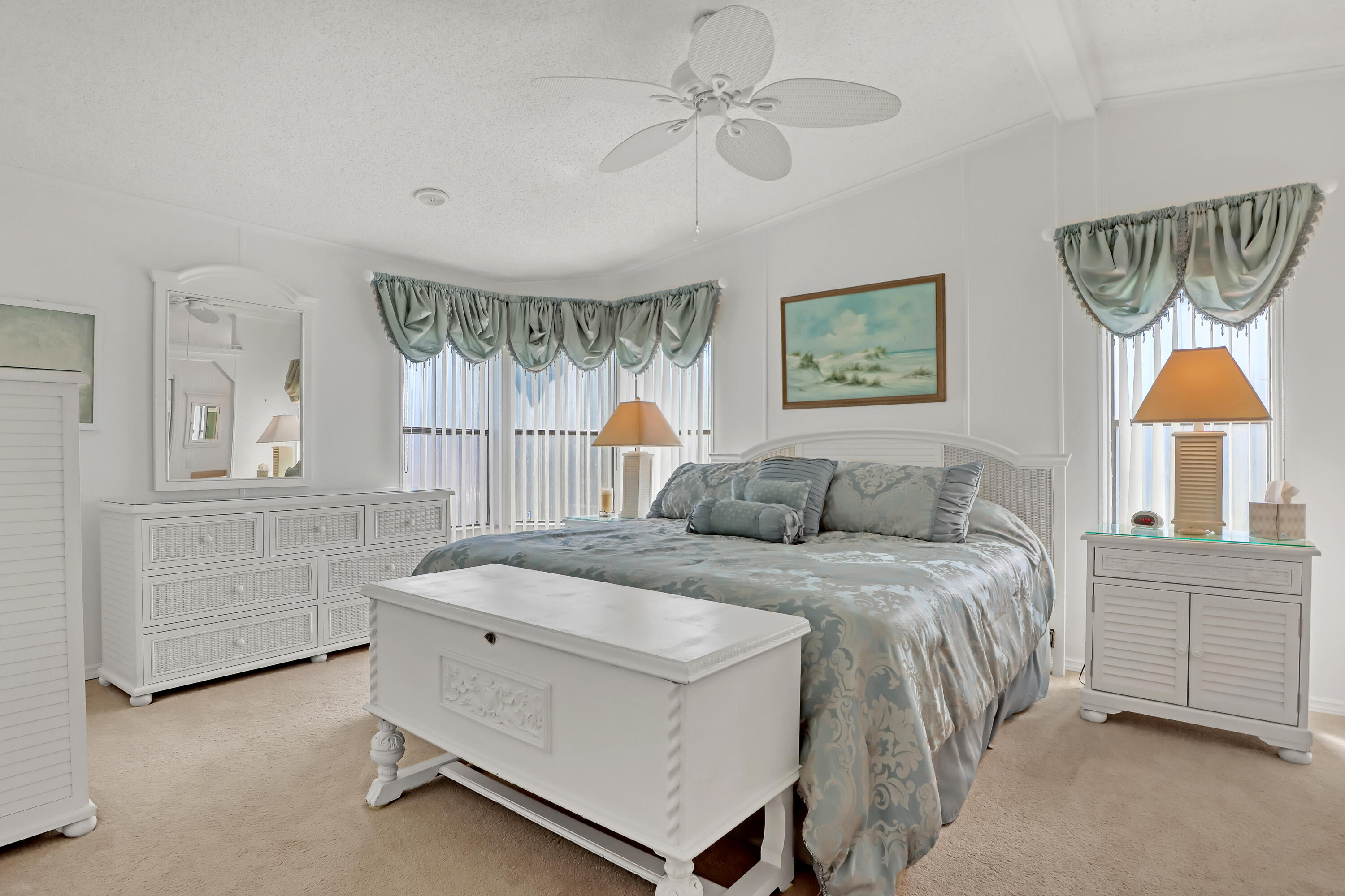 464 Dolphin Circle Barefoot Bay, FL 32976 - Photo 16 of 42 a bedroom with a bed and a chandelier