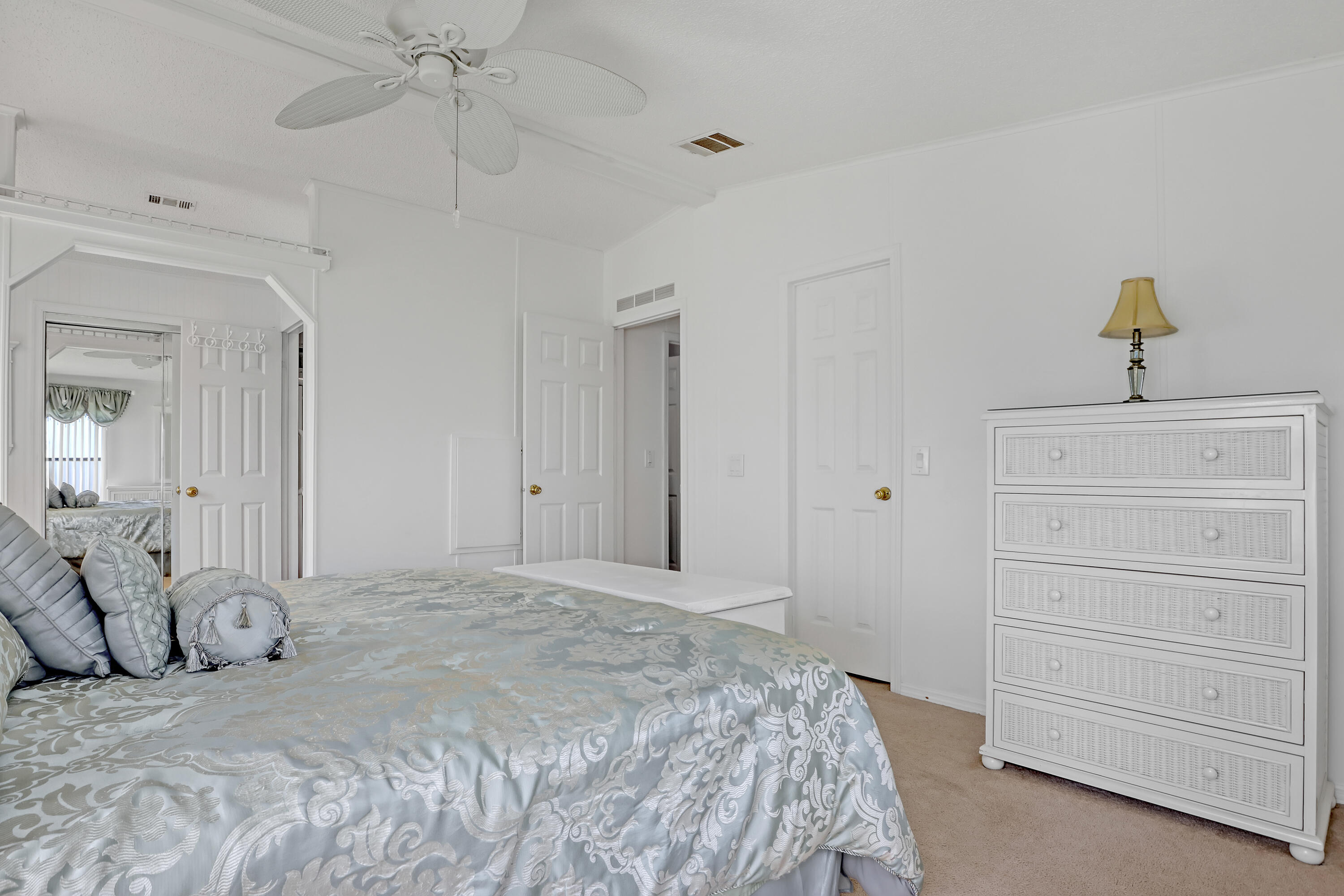 464 Dolphin Circle Barefoot Bay, FL 32976 - Photo 17 of 42 a bedroom with a bed and a chandelier