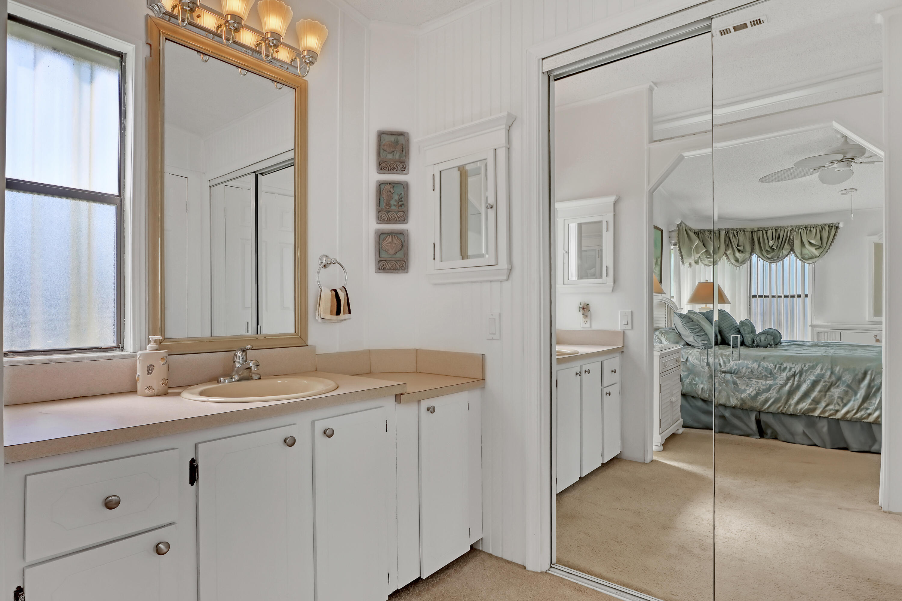 464 Dolphin Circle Barefoot Bay, FL 32976 - Photo 18 of 42 a spacious bathroom with a granite countertop sink mirror and double