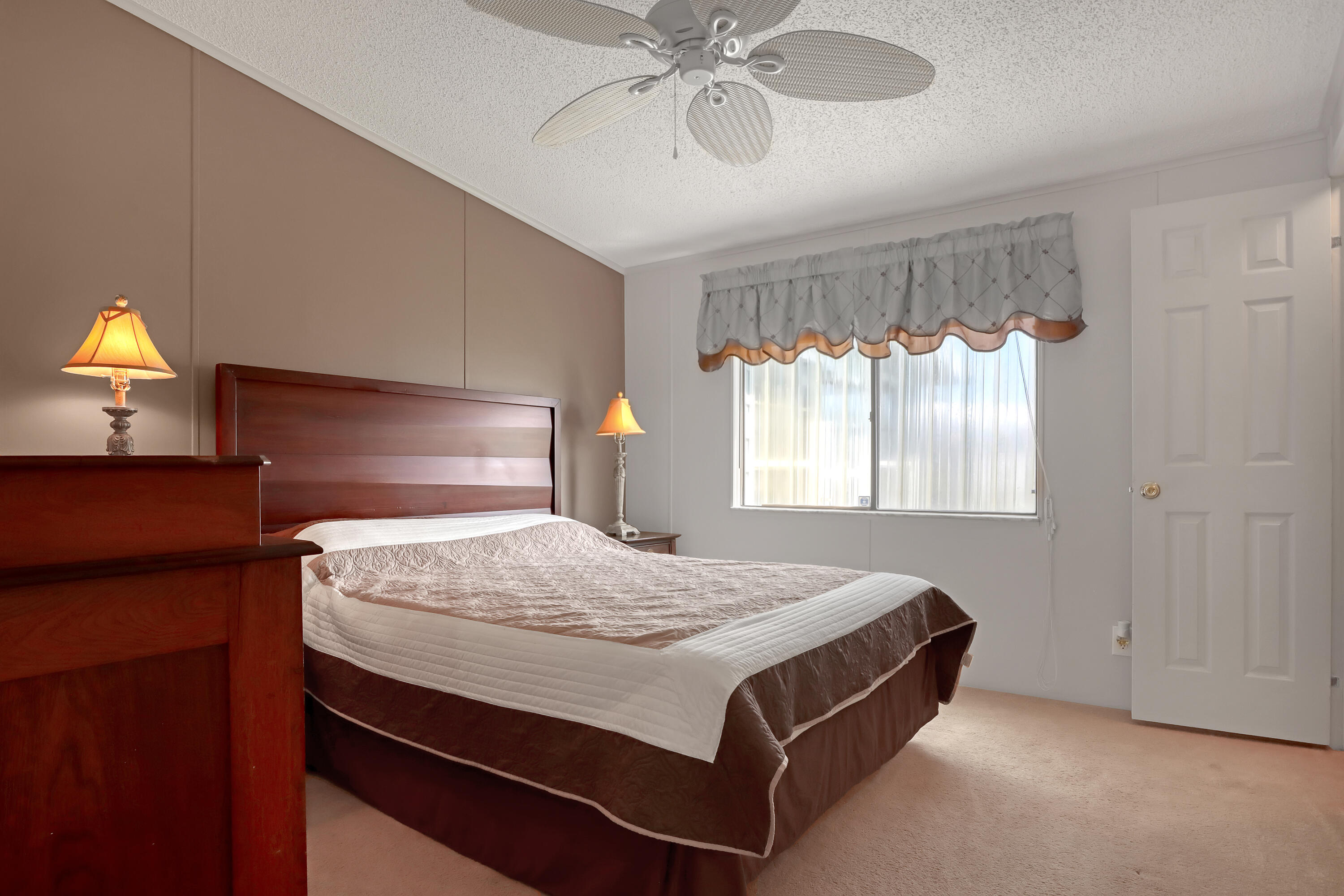 464 Dolphin Circle Barefoot Bay, FL 32976 - Photo 20 of 42 a bedroom with a bed and window