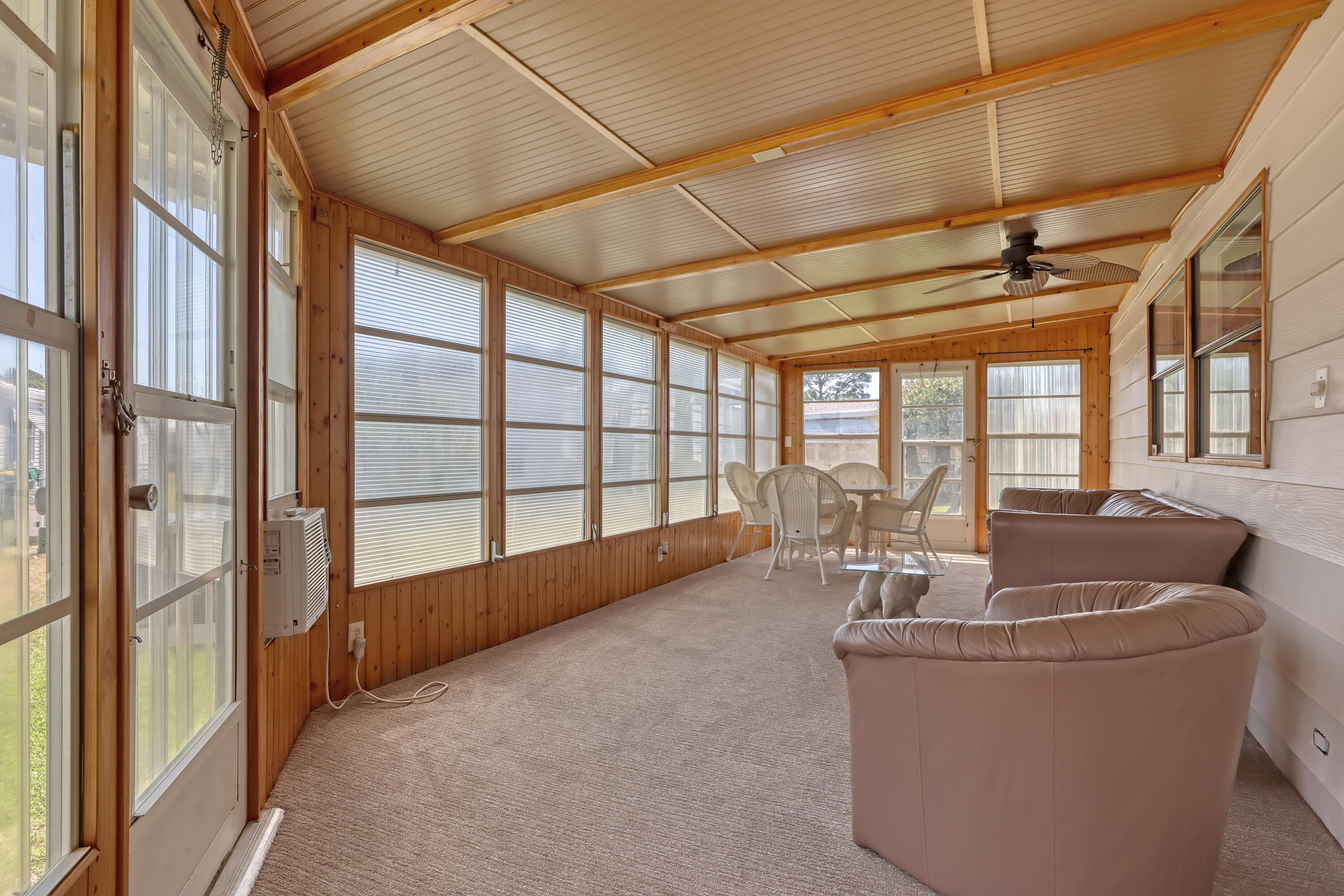 464 Dolphin Circle Barefoot Bay, FL 32976 - Photo 24 of 42 a living room with furniture and a floor to ceiling window