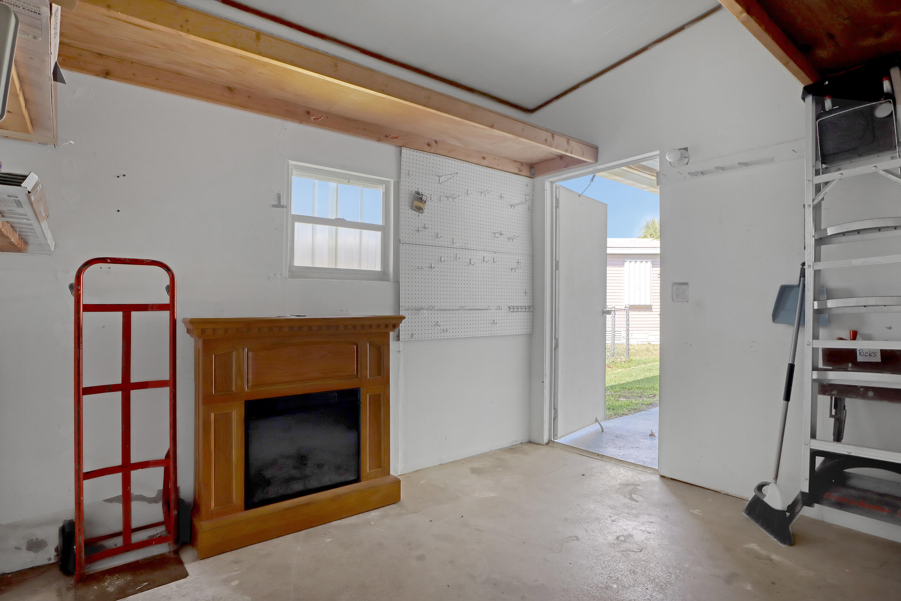 464 Dolphin Circle Barefoot Bay, FL 32976 - Photo 27 of 42 a view of a livingroom with a fireplace and workspace