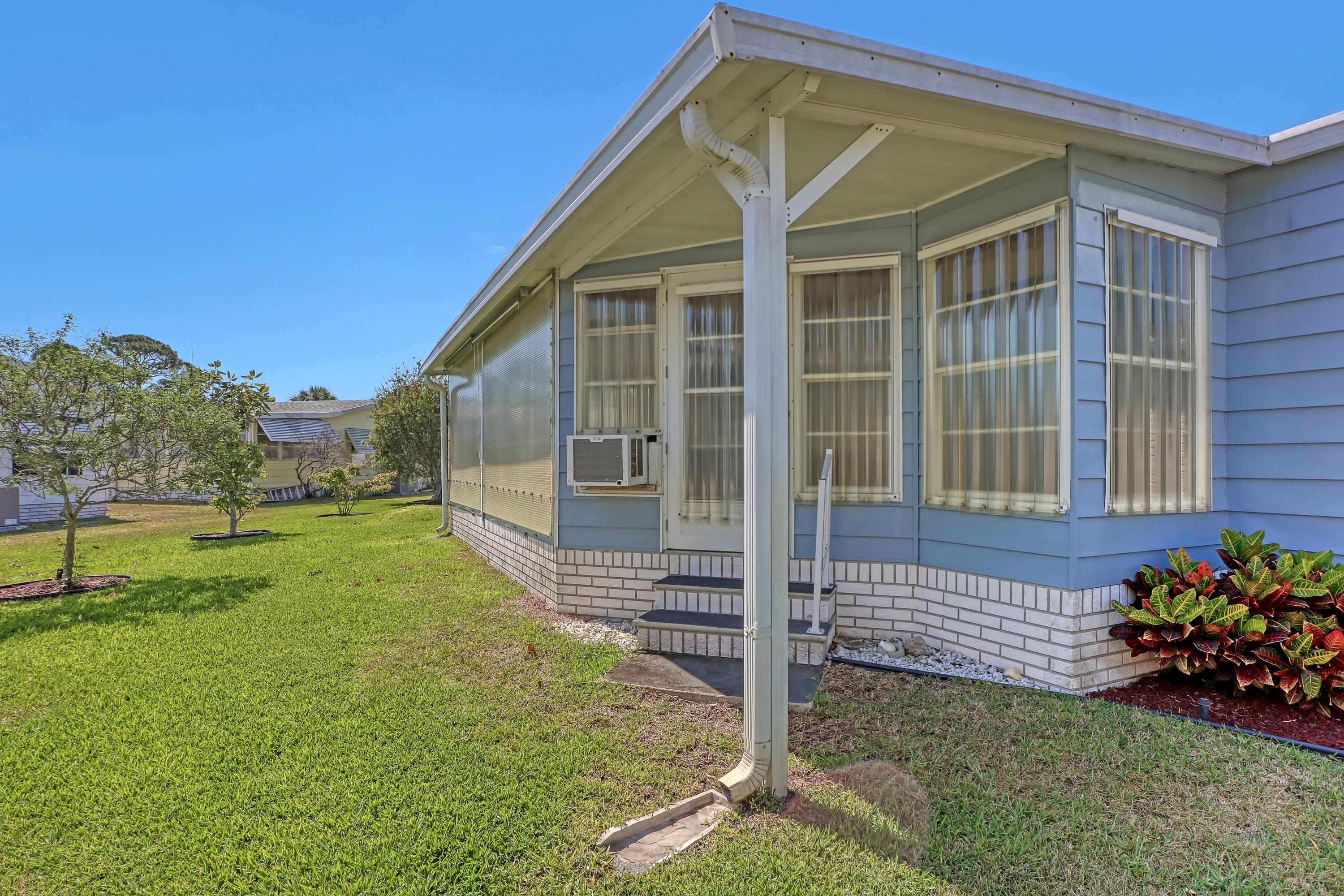 464 Dolphin Circle Barefoot Bay, FL 32976 - Photo 28 of 42 a front view of a house with a yard