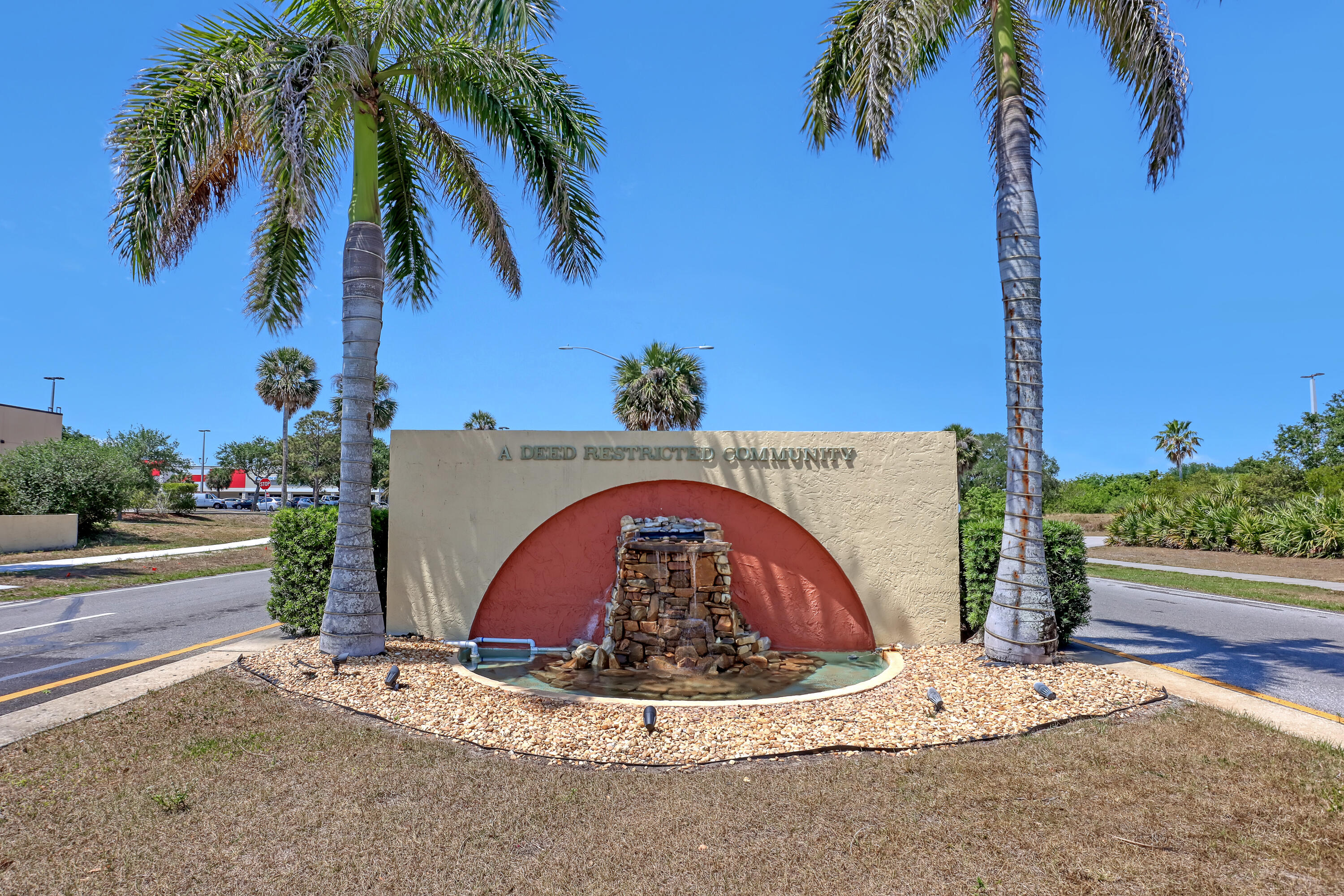 464 Dolphin Circle Barefoot Bay, FL 32976 - Photo 31 of 42 a view of swimming pool with a garden and trees