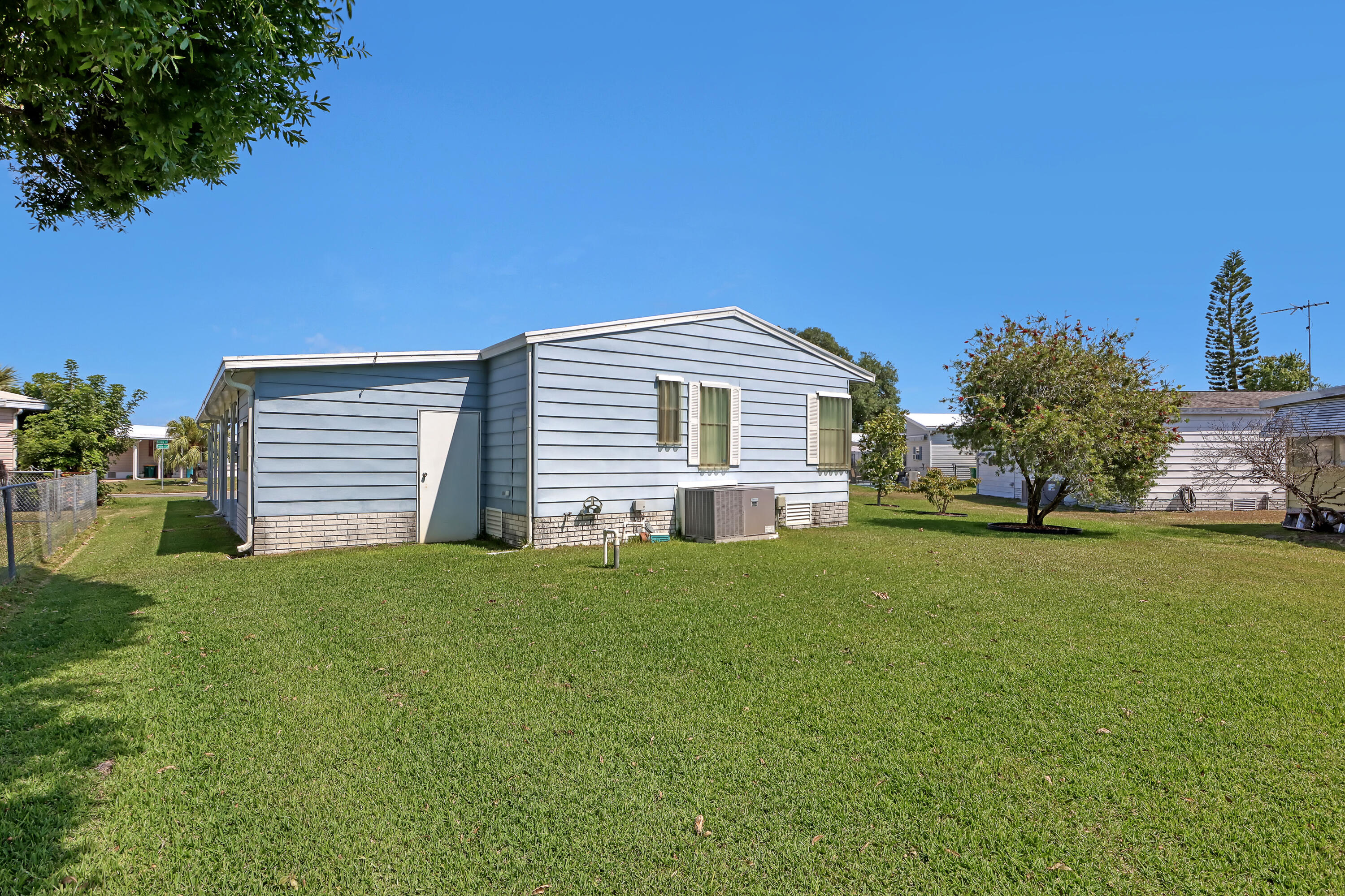 464 Dolphin Circle Barefoot Bay, FL 32976 - Photo 42 of 42 a front view of a house with a garden