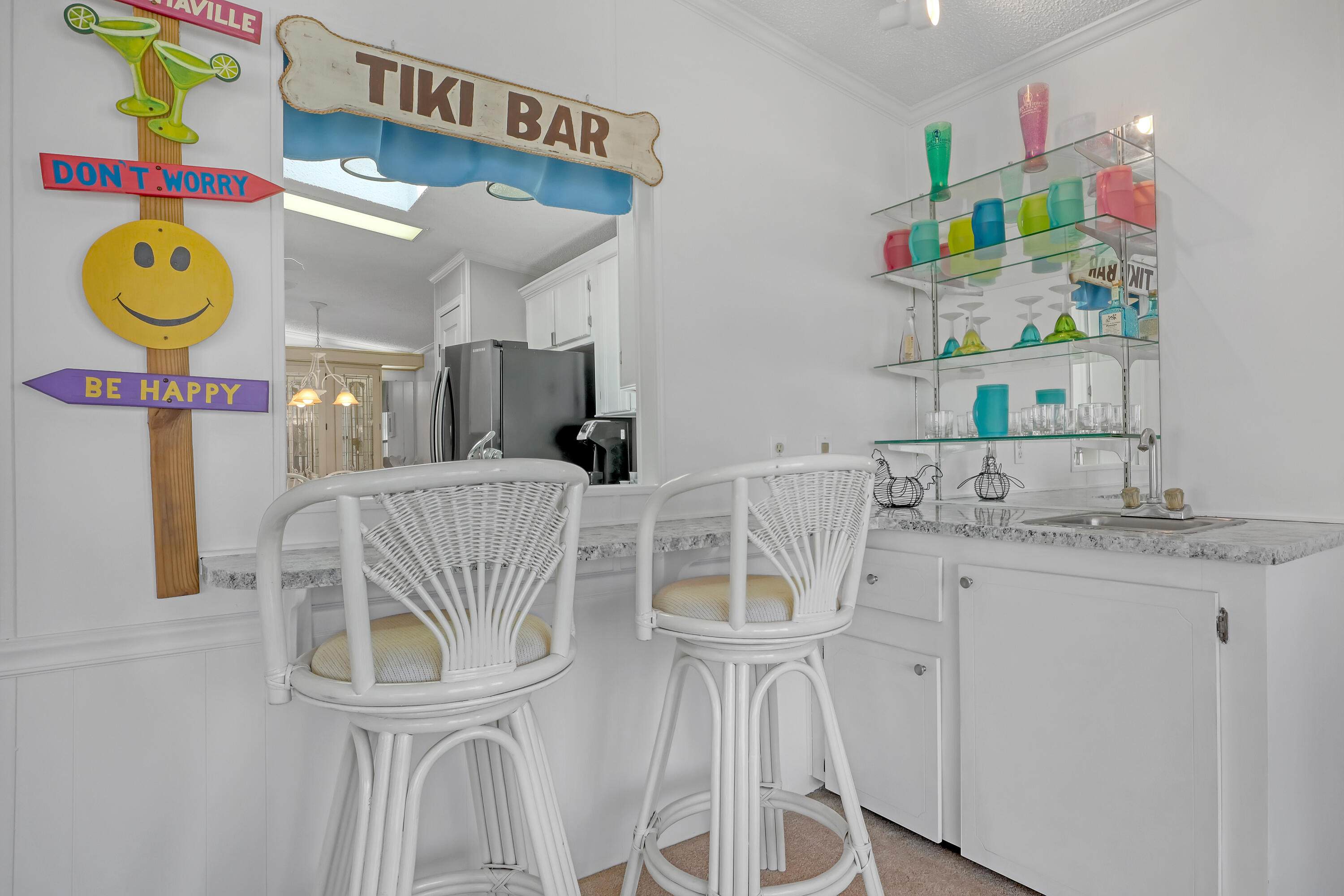 464 Dolphin Circle Barefoot Bay, FL 32976 - Photo 6 of 42 a bathroom with a sink a mirror and painting on the wall