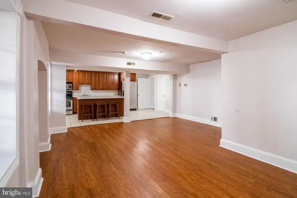 a view of a room with wooden floor and a window