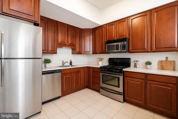 a kitchen with stainless steel appliances granite countertop a refrigerator stove a sink and dishwasher