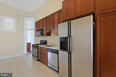 a kitchen with stainless steel appliances a refrigerator sink and cabinets