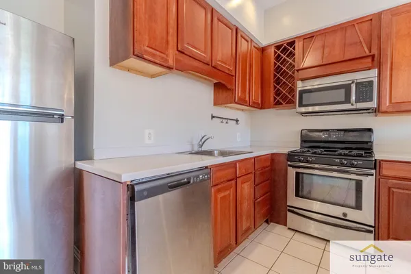 a kitchen with stainless steel appliances granite countertop a sink and cabinets
