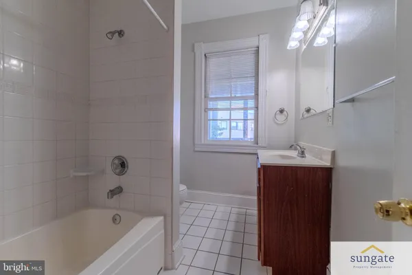 a bathroom with a sink a toilet and a window