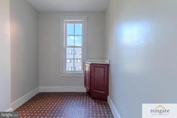 a white toilet sitting next to a window