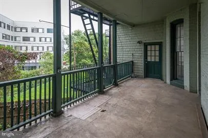 a view of a balcony with a floor to ceiling window and wooden fence