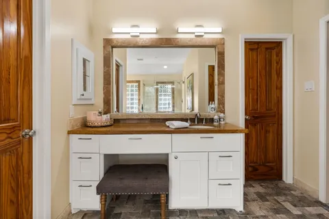a bathroom with a granite countertop sink a toilet and a shower