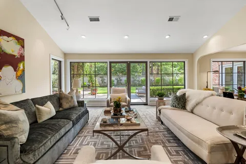 a living room with furniture and a floor to ceiling window