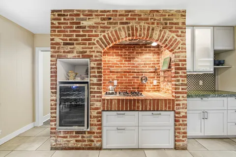 a kitchen with granite countertop white cabinets and stainless steel appliances
