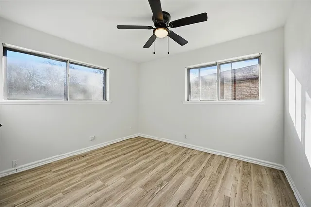 a view of room with window and wooden floor