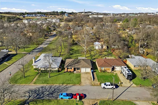 an aerial view of residential houses with outdoor space and street view