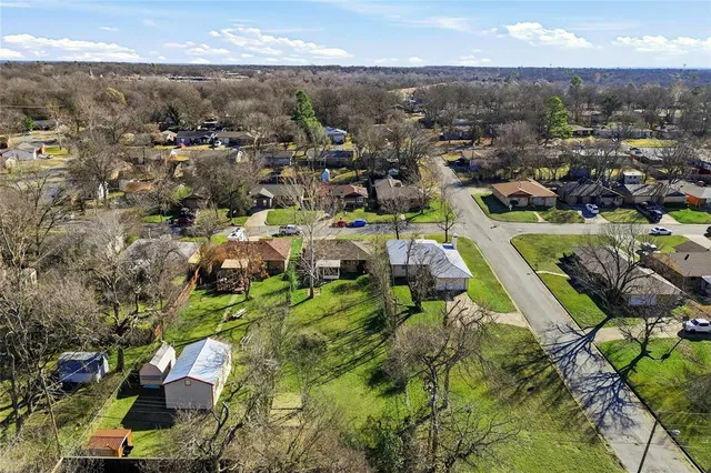 an aerial view of residential houses with outdoor space