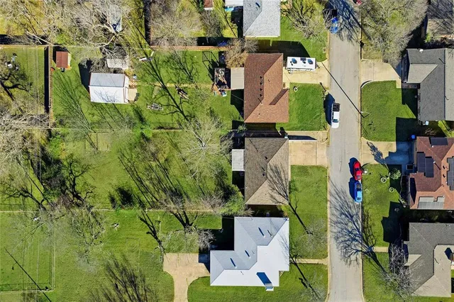 an aerial view of multiple houses with yard