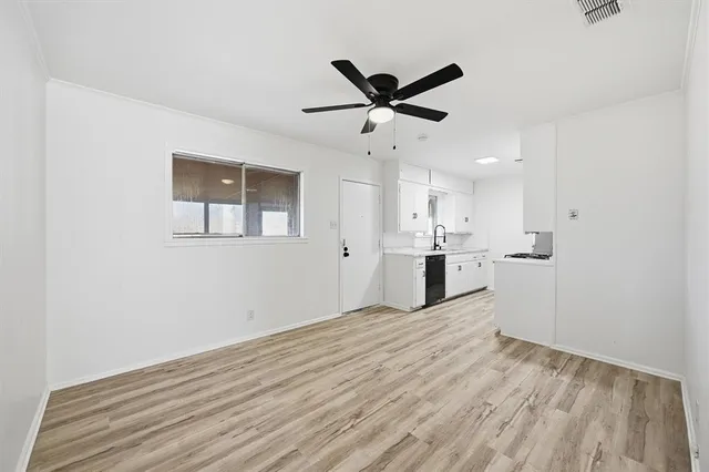 a view of a kitchen with wooden floor and a sink