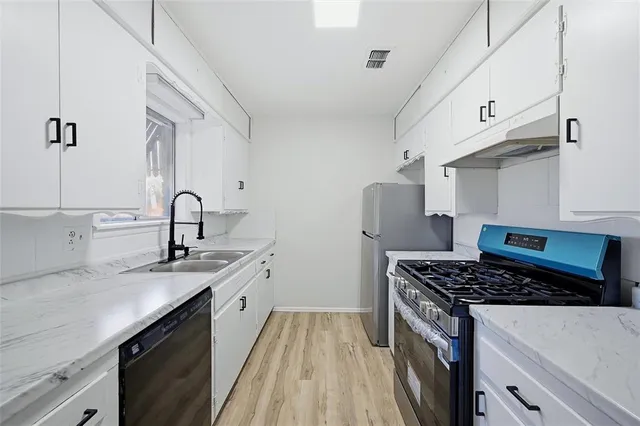 a kitchen that has a sink and a stove in it