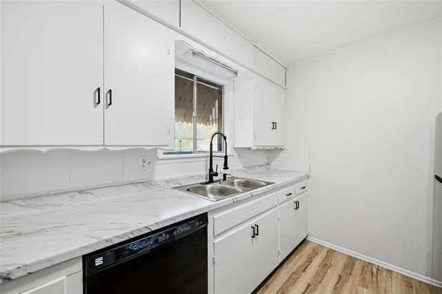 a kitchen with a sink and cabinets