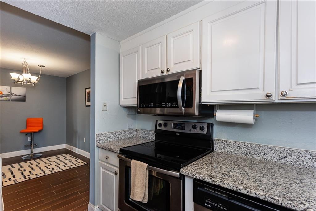 375 Ralph McGill Boulevard Northeast, Unit 1701 Atlanta, GA 30312 - Photo 11 of 33 a kitchen with stainless steel appliances granite countertop a stove and a sink