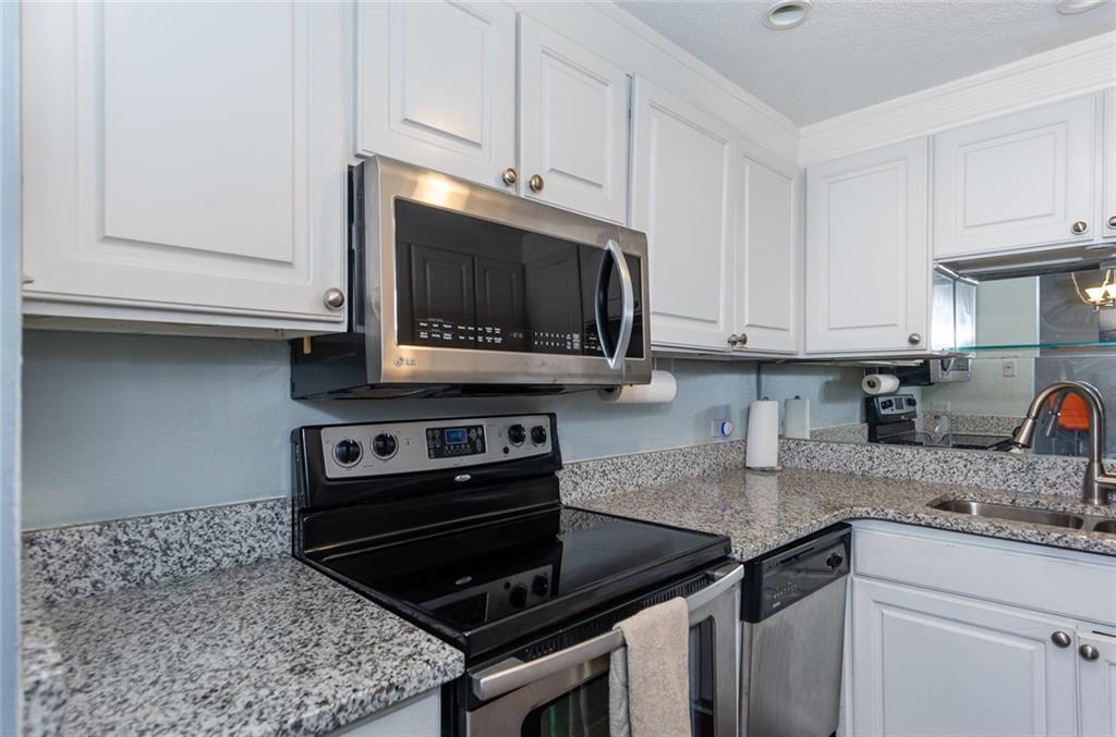 375 Ralph McGill Boulevard Northeast, Unit 1701 Atlanta, GA 30312 - Photo 12 of 33 a kitchen with granite countertop a stove and a sink