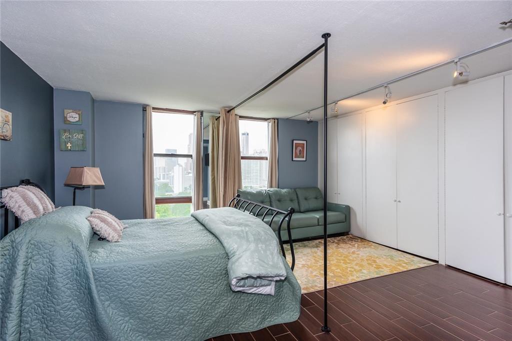375 Ralph McGill Boulevard Northeast, Unit 1701 Atlanta, GA 30312 - Photo 18 of 33 a bedroom with a bed and a window
