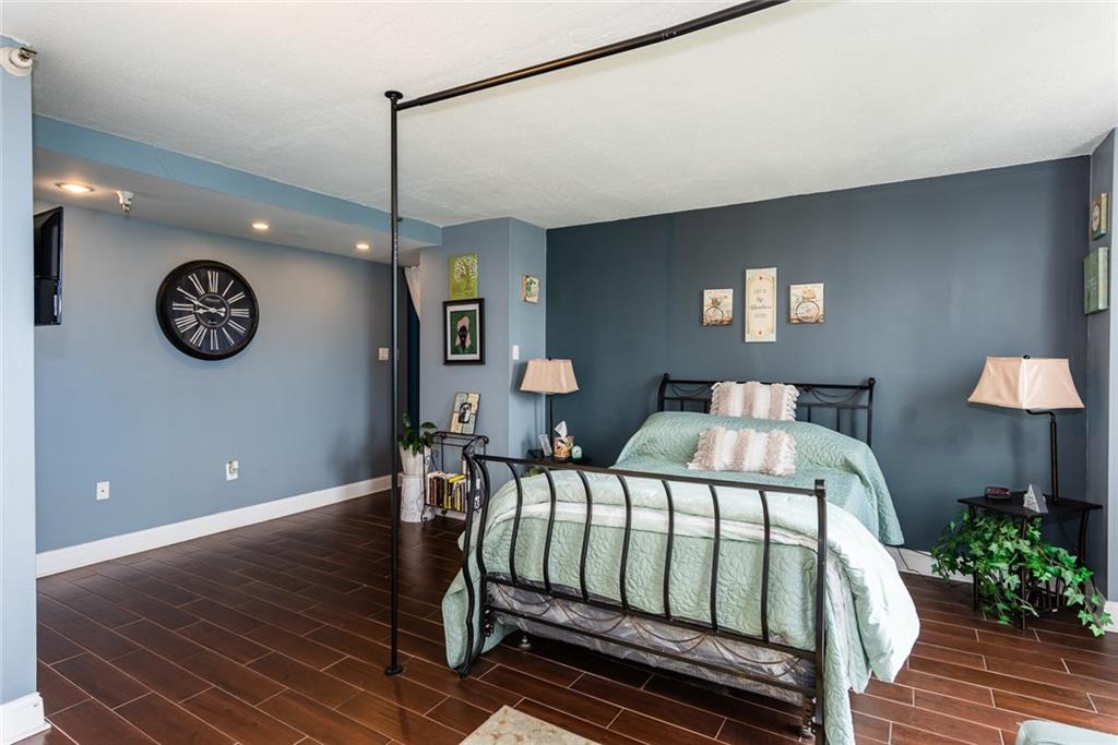 375 Ralph McGill Boulevard Northeast, Unit 1701 Atlanta, GA 30312 - Photo 20 of 33 a bedroom with a bed and a chandelier