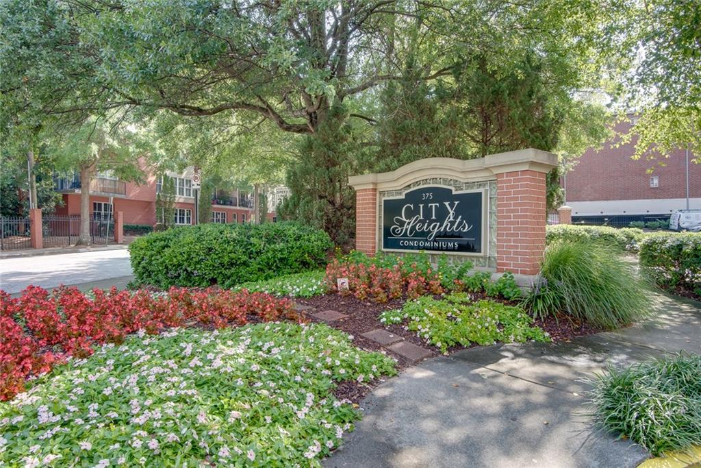 375 Ralph McGill Boulevard Northeast, Unit 1701 Atlanta, GA 30312 - Photo 2 of 33 a sign that is sitting in front of flowers