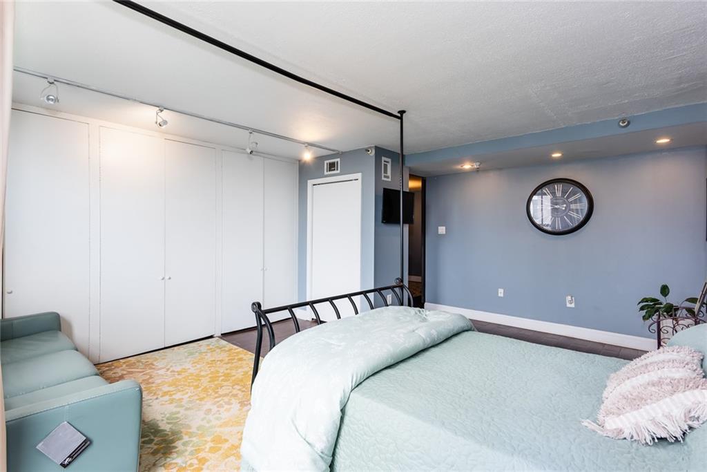375 Ralph McGill Boulevard Northeast, Unit 1701 Atlanta, GA 30312 - Photo 22 of 33 a bedroom with a bed and a chandelier