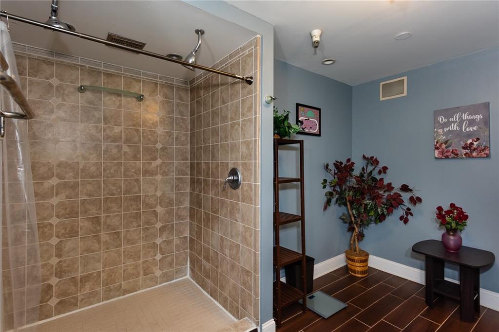 375 Ralph McGill Boulevard Northeast, Unit 1701 Atlanta, GA 30312 - Photo 27 of 33 a bath room with a potted plant and a shower