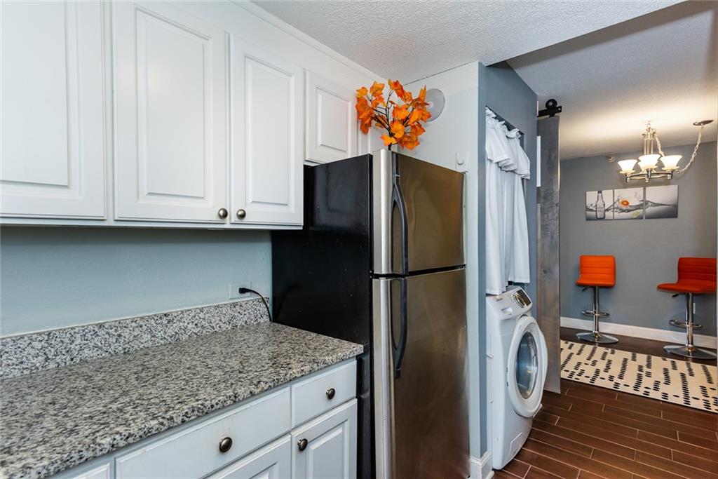 375 Ralph McGill Boulevard Northeast, Unit 1701 Atlanta, GA 30312 - Photo 10 of 33 a kitchen with stainless steel appliances granite countertop a refrigerator and a cabinets
