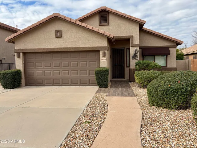 a front view of a house with a yard and garage