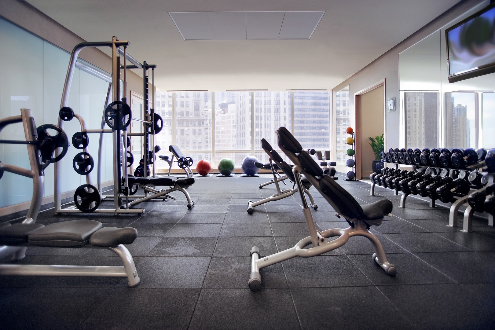 401 North Wabash Avenue, Unit 54E Chicago, IL 60611 - Photo 27 of 29 a room with gym equipment and large mirror