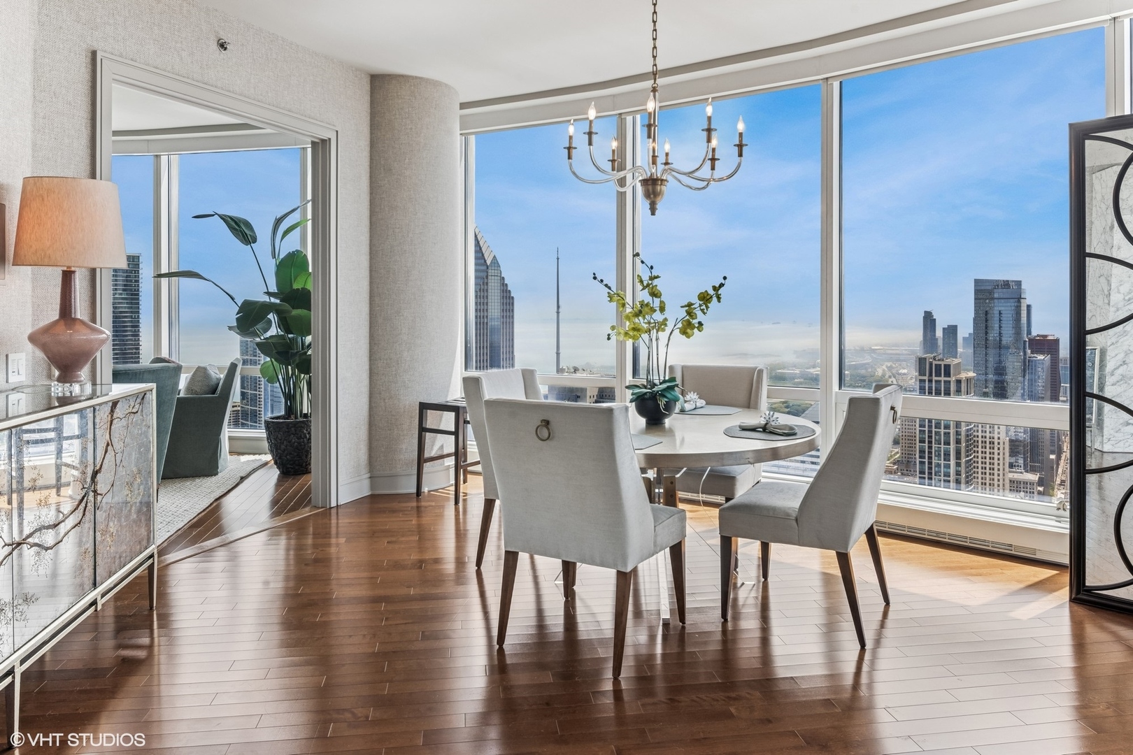401 North Wabash Avenue, Unit 54E Chicago, IL 60611 - Photo 7 of 29 a view of a dining room with furniture a chandelier and wooden floor